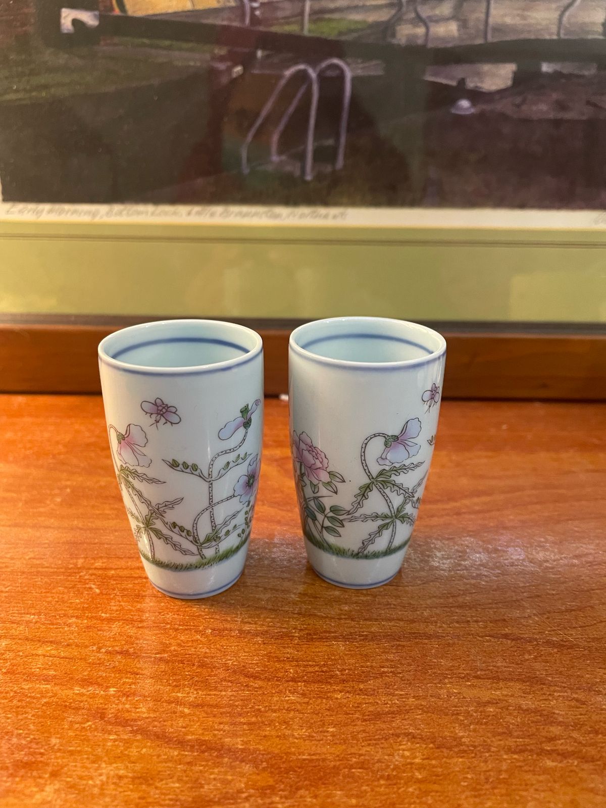 A pair of vintage, hand-painted mini ceramic vases.