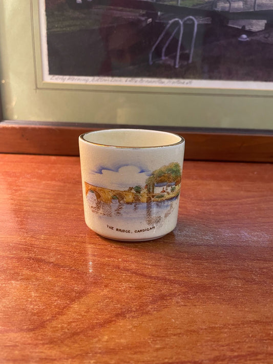 an antique teacup, likely Edwardian, depicting the Pontypridd Bridge in Cardigan, Wales