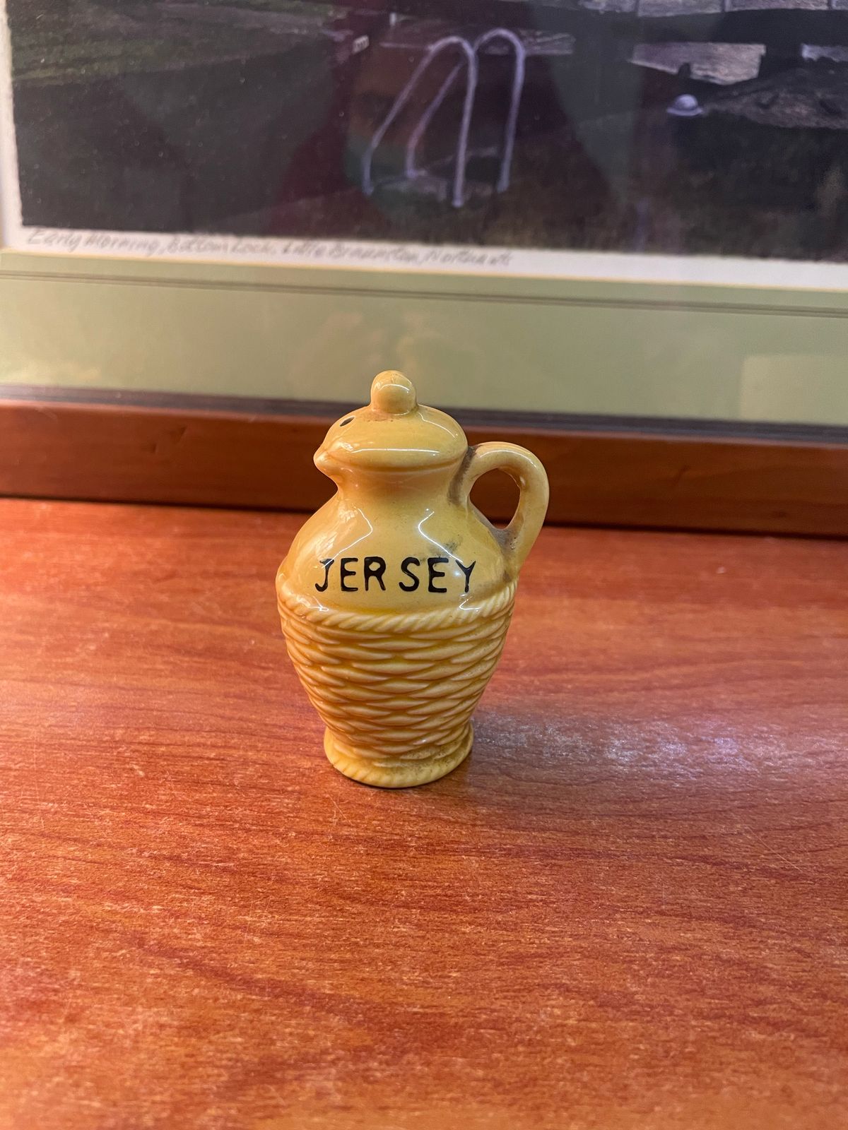 a vintage Jersey salt or pepper shaker, likely ceramic, shaped like a small jug or pot.